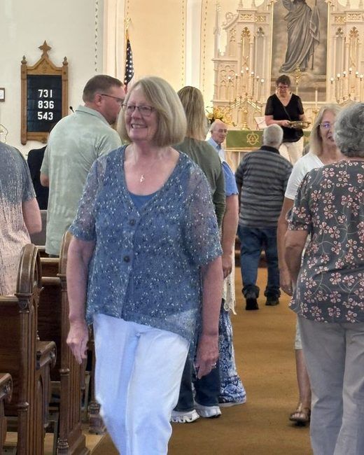 Members greeting one another in the aisle after worship