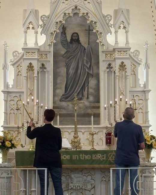 Two members lighting the altar candles
