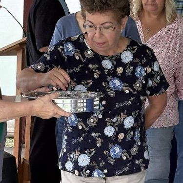 Deacon Laurie Finn serving communion